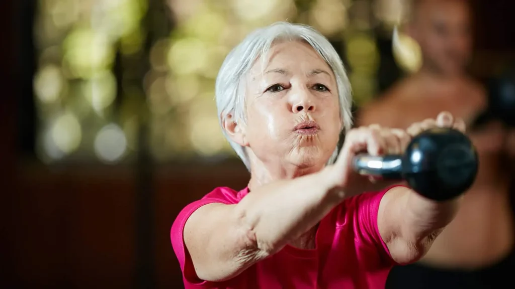 Woman doing resistance band exercises for toned arms Sunbury-on-Thames